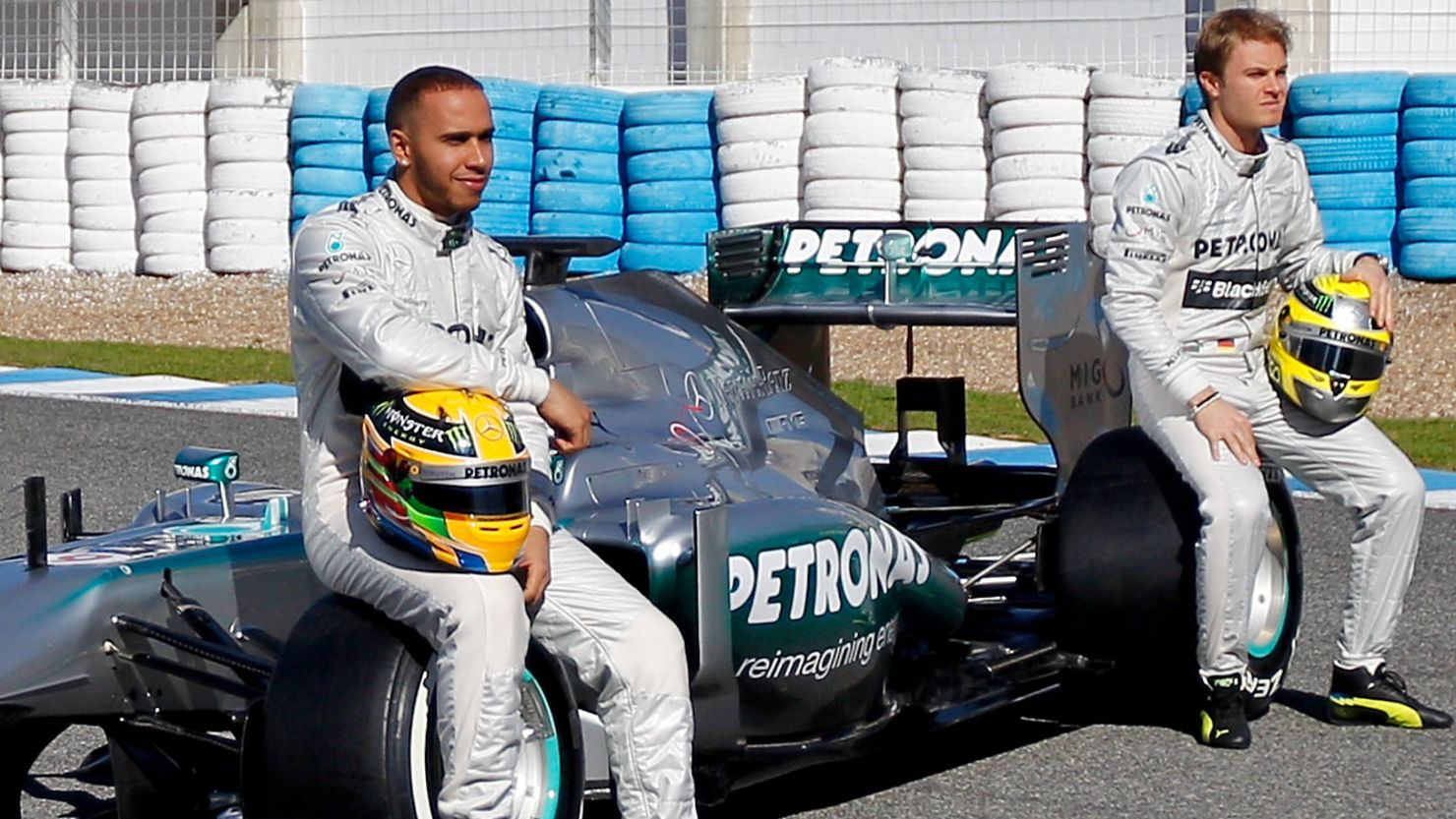 Lewis Hamilton and Nico Rosberg pose with the new Mercedes car for the 2013 Formula One season.