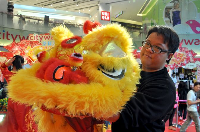 Master Ha, 28, showing a lion with half-closed eyelids. <br /><br />His family's dragon and lion dance business has been operating for three generations. Ha has been practicing martial arts and lion dance since he was three years old. <br /><br />"The fifth day of LNY (February 4) is a very good (feng shui) day to begin business this year, so we've been booked to tour a few shopping malls on that day including IFC, CityWalk and Harbour City," said Ha.<br /><br /><em>Travelers interested in experiencing the lion dance can book a class with the Ha Tak Kin Martial Art Society. The school welcomes groups of six or above, each class costs about HK$200 ($26) per person.</em><br /><br /><a href="http://liondance.com.hk/pub/org/" target="_blank" target="_blank"><em>Ha Tak Kin Martial Art Society Ltd.</em></a><em>, 2/F, 460 Nathan Road, Kowloon, Hong Kong; +852 2384 0610</em><br /><br /><em>IFC, 8 Finance Street, Central, Hong Kong; +852 2295 3308</em><br /><br /><em>CityWalk, 1 Yeung Uk Road, Tsuen Wan, Hong Kong; +852 3926 5700</em><br /><br /><em>Harbour City, 7-27 Canton Road, Tsim Sha Tsui, hong Kong; +852 2118 8666</em><br /><br /><em>Story original published February 2013. Updated January 26, 2014.</em>