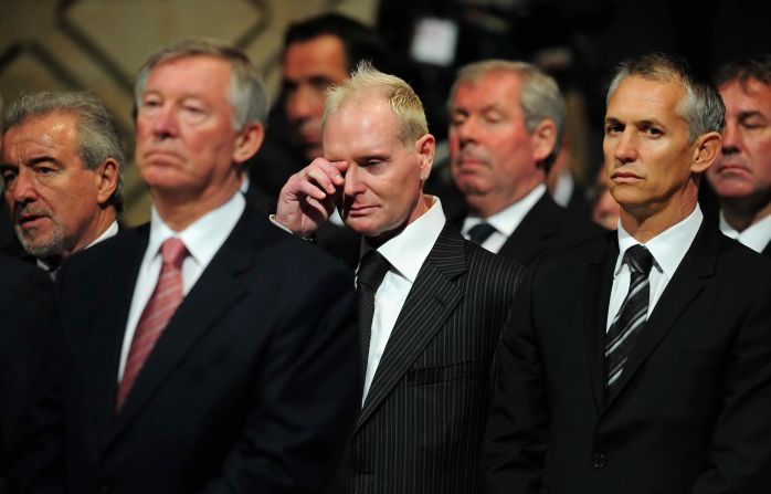 Paul Gascoigne wipes away a tear at the funeral of his former England boss Bobby Robson. Gary Lineker is on his left.  
