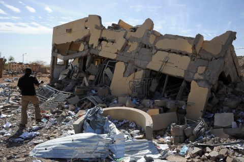 A man searches through the ruins of a building destroyed by French airstrikes in Douentza, Mali, on Tuesday, February 5.  The town was retaken by French and Malian troops in January. 