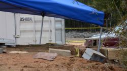A tent covers the bunker where where a 5-year-old child was rescued by law enforcement after being held for nearly a week. FBI agents placed the blue tent over the bunker to protect evidence below.