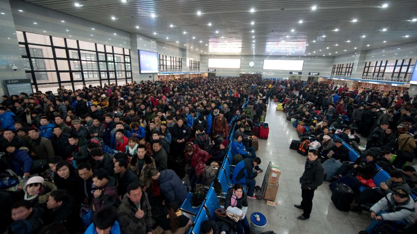 Lunar New Year travellers wait for their train at the West Railway Station in Beijing on January 31, 2013.