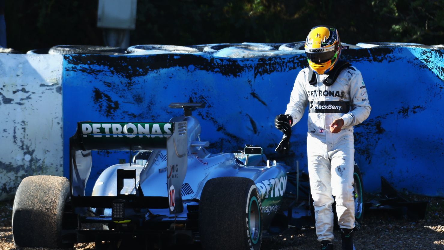 Lewis Hamiton walks away from the wreckage of his new Mercedes following the crash at Jerez, Spain.