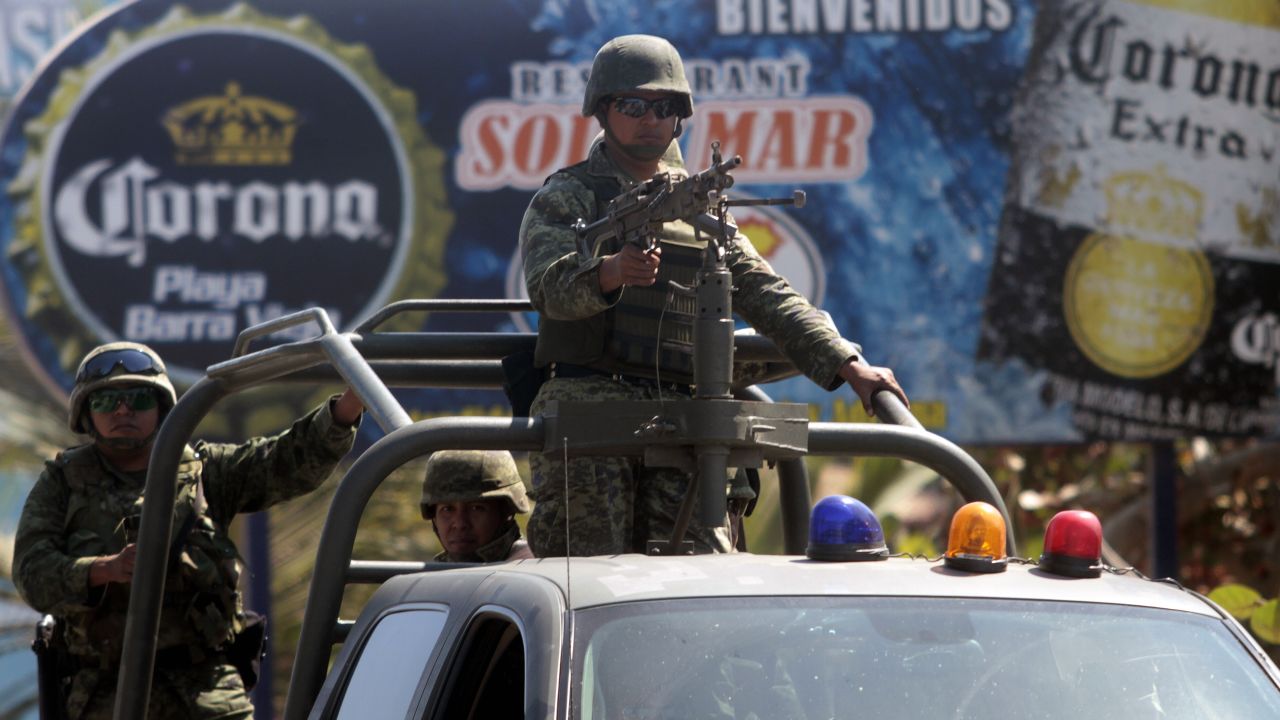 (File) Soldiers stand guard in Acapulco, in the Mexican state of Guerrero, on February 5, 2013. 