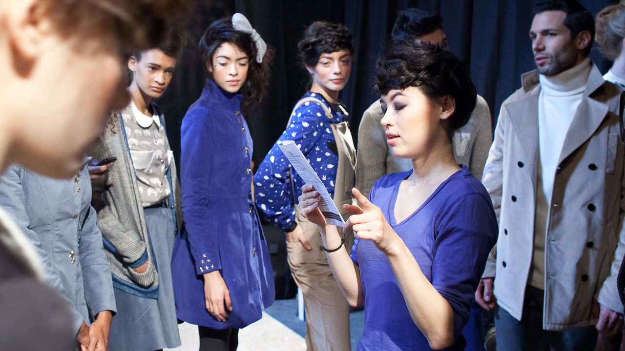 Surrounded by models, designer Leanne Mai-ly Hilgart directs her first Fashion Week show. She started Vaute Couture in 2008 and has earned a global following.