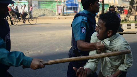 (File photo) Police charge a suspected Jamaat-e-Islami activist during a nationwide strike in Dhaka on February 6, 2013.