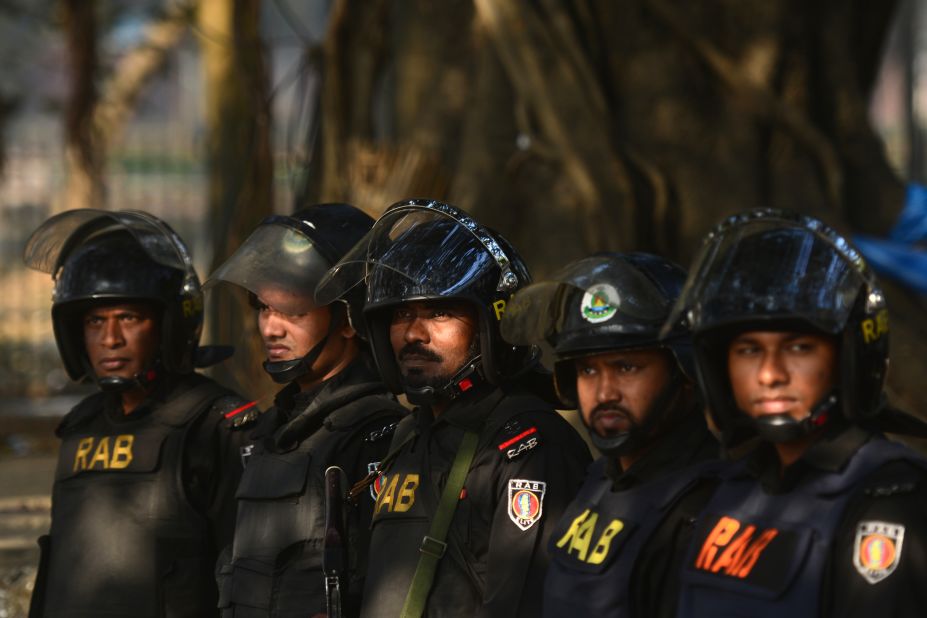 Rapid Action Battalion personnel keep watch outside the International Crimes Tribunal court in Dhaka on February 5.