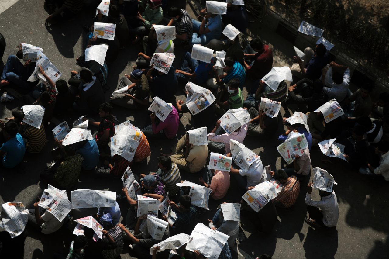 Bangladeshi social activists and bloggers in Dhaka use newspapers as hats during a demonstration demanding death sentences for war criminals on February 6.