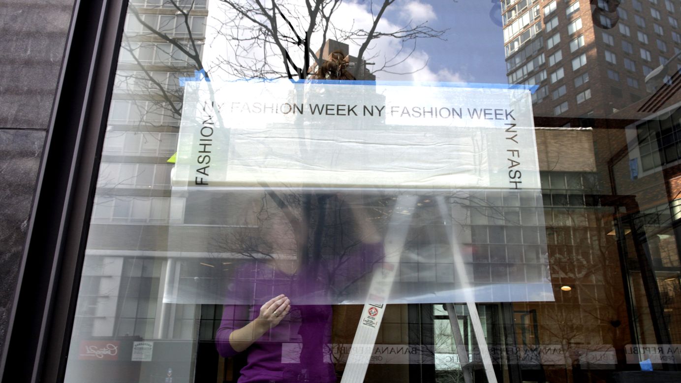 A store near the Lincoln Center hangs a Fashion Week sign in its window on February 4.