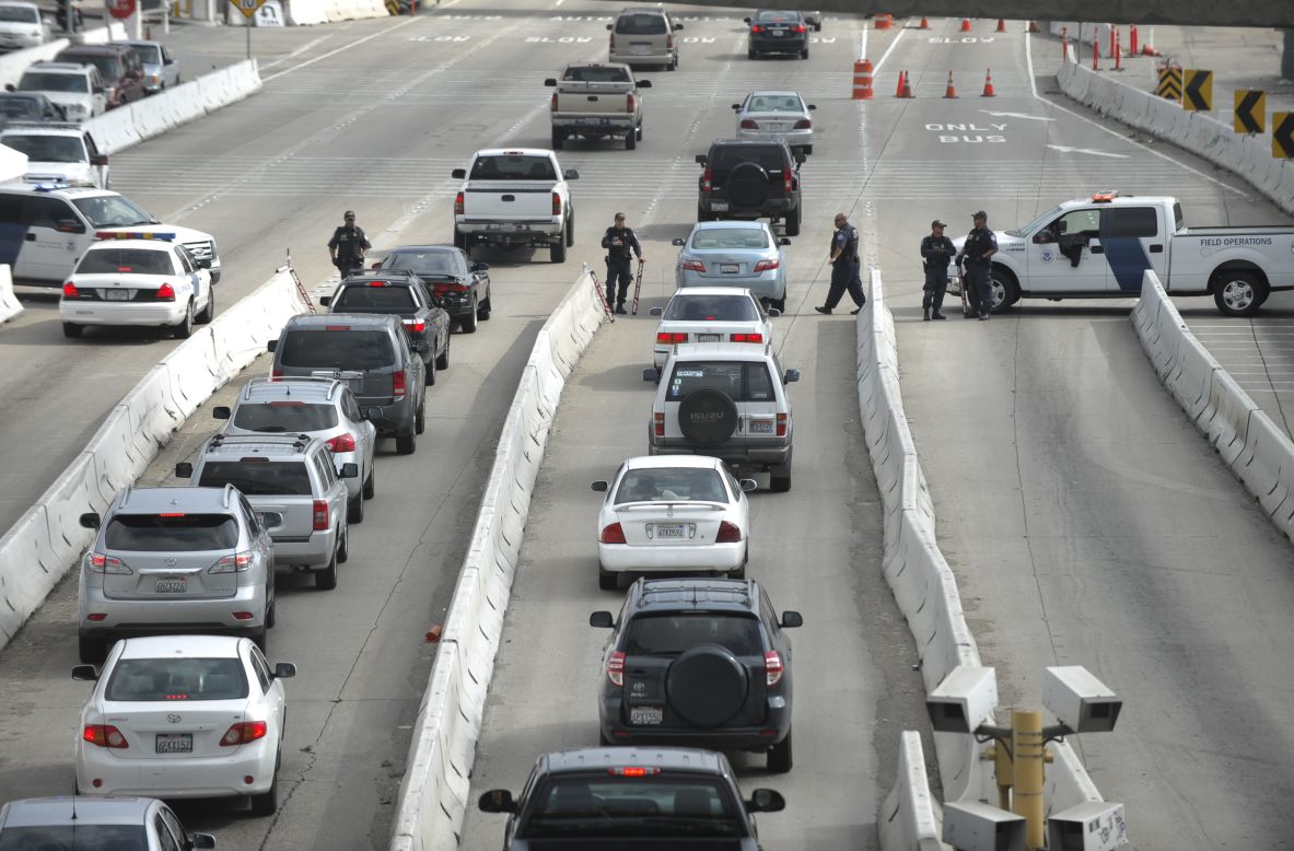 Department of Homeland Security officers search vehicles at the San Ysidro Port of Entry in San Diego on February 7 as they search for former LAPD officer Christopher Dorner. 
