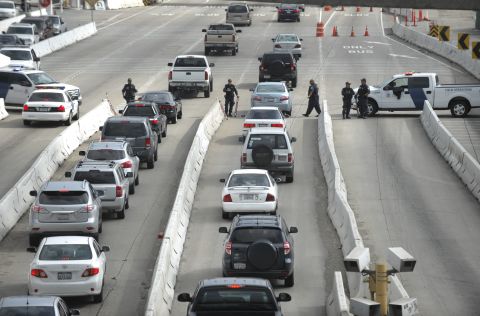 Department of Homeland Security officers search vehicles at the San Ysidro Port of Entry in San Diego on February 7 as they search for former LAPD officer Christopher Dorner. 