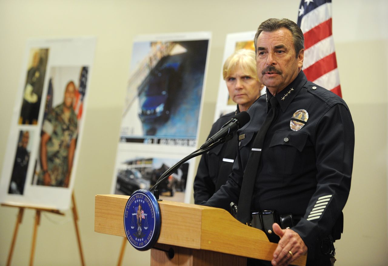 Los Angeles Police Chief Charlie Beck speaks at a press conference about the manhunt for Dorner as photos of the suspect stand in the background on February 7.