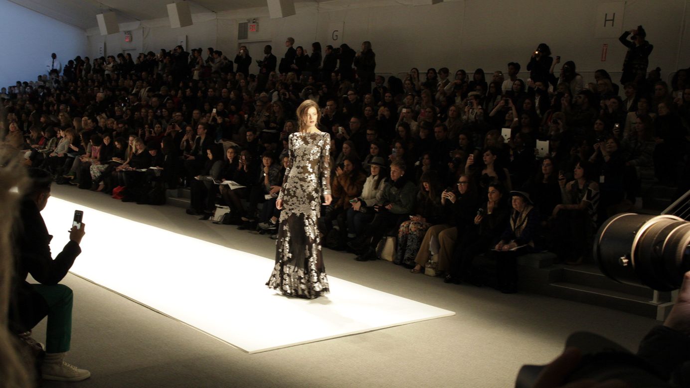 A model stops at the end of the runway on February 7. She's wearing a dress from Tadashi Shoji's latest collection.