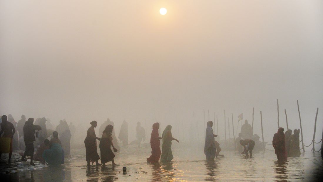 Devotees walk into the waters at the Sangam in Allahabad on January 13.