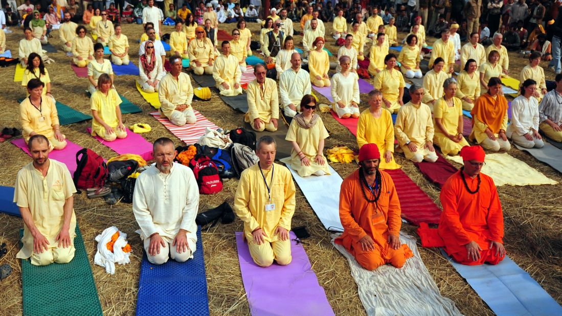 Foreign devotees participate in yoga on the banks of the Sangam on January 16.