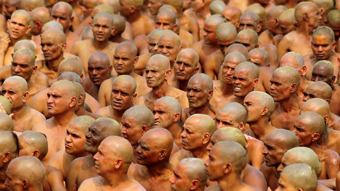 Newly initiated Naga Sadhus, translated "naked holy men," prepare to perform rituals on the banks of the Ganges River on February 6. The men wear little to no clothing during the rituals, which include running into the river to bathe.