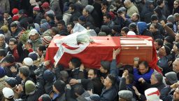 People carry the coffin of late opposition leader Chokri Belaid during his funeral procession which makes its way to the nearby cemetery of El-Jellaz where Belaid is to be buried on February 8, 2013 in the Djebel Jelloud district, a suburb of Tunis. 