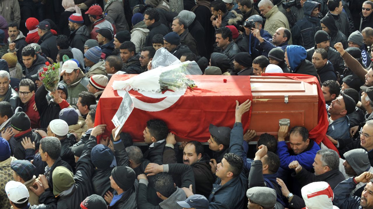 Mourners carry the coffin of late opposition leader Chokri Belaid during his funeral procession.  Belaid was buried on Friday. 
