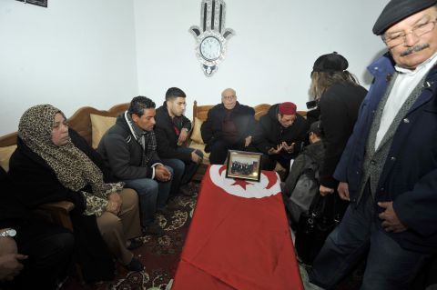 Family members and supporters mourn on February 7, 2013 around the of coffin of Chokri Belaid, an outspoken opposition leader who was assassinated the previous day, at his family home in the Tunisian capital's suburb of Jebel Jelloud.