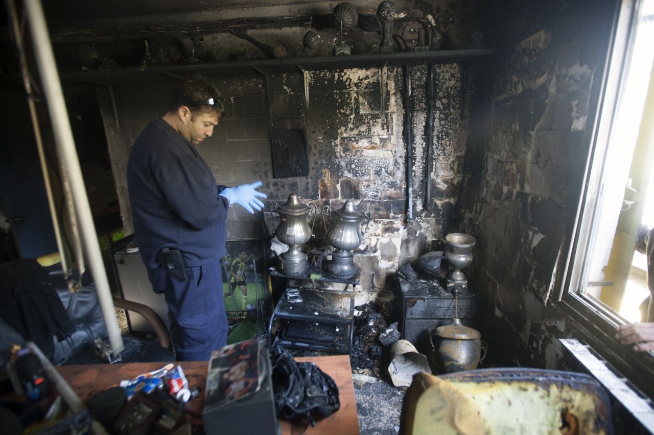A club official examines the charred remains of the trophies won by Israeli league side Beitar Jerusalem after an arson attack on its clubhouse.   