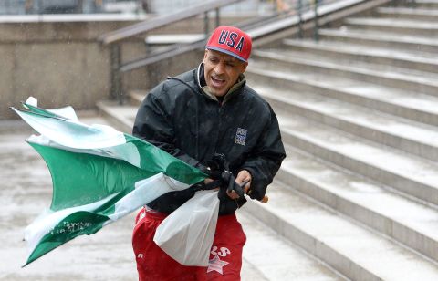 Ricky Varona copes with the wind and precipitation February 8 in New York.