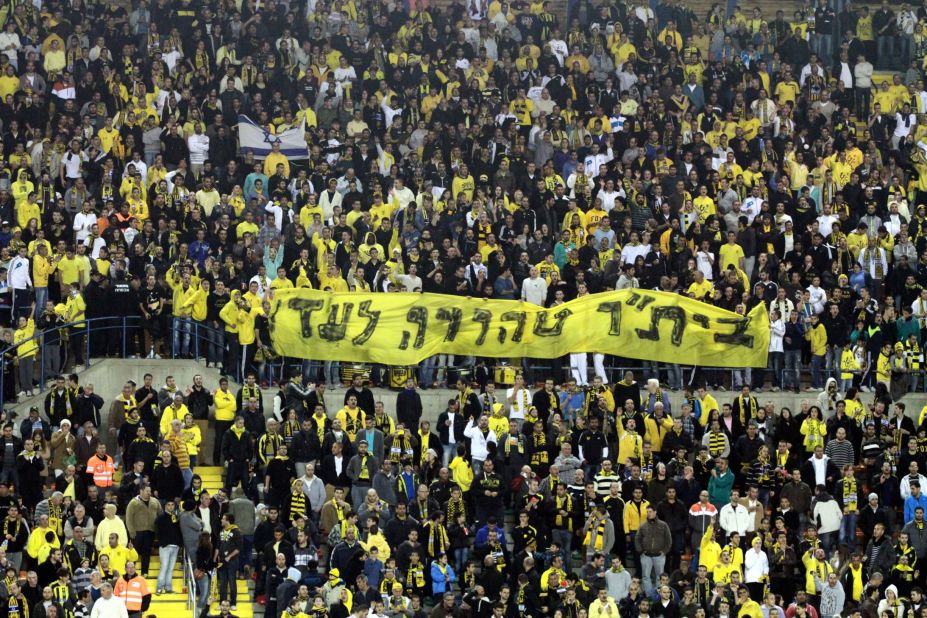 Beitar Jerusalem fans display a banner reading "Beitar -- pure forever" at a match on January 26 after their signing of two Muslim players.