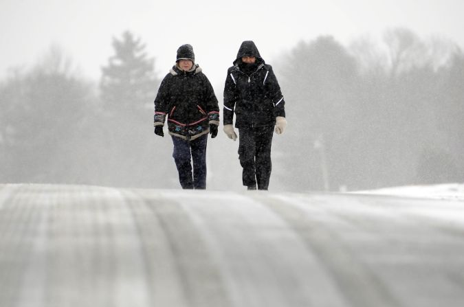 Ines Cuadrado, left, and Anne Levine trek along a snow-covered road in Middlefield, Connecticut, on February 8.