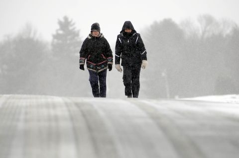 Ines Cuadrado, left, and Anne Levine trek along a snow-covered road in Middlefield, Connecticut, on February 8.