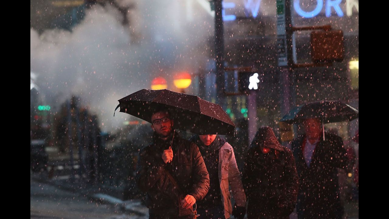 Pedestrians battle wind, snow and sleet in Manhattan on Friday.