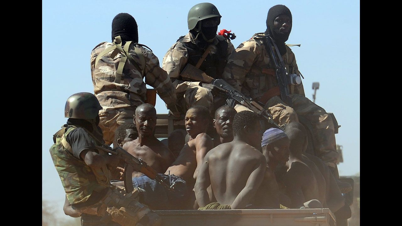 Malian soldiers transport in a pickup truck a dozen suspected Islamist rebels on Friday, February 8, after arresting them north of Gao.  A suicide bomber blew himself up on February 8 near a group of Malian soldiers in the northern city, where Islamist rebels driven from the town have resorted to guerilla attacks.