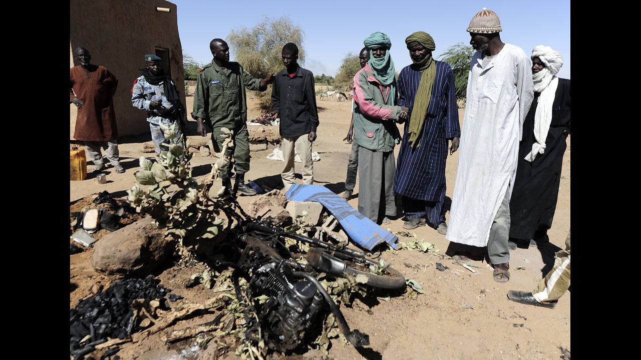 Malians look at the charred motorcycle used by a suicide bomber before he blew himself up near a group of Malian soldiers on February 8. The act marked the first suicide attack in the embattled west African nation since the start of a French-led offensive to oust the Islamists from Mali's north, where they had controlled key towns for 10 months.
