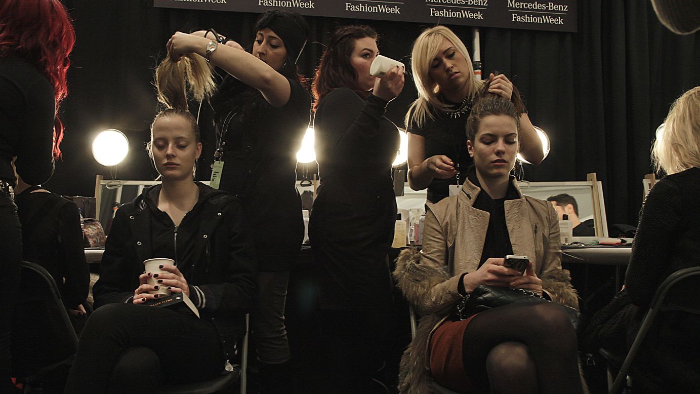 Backstage at the Carmen Marc Valvo show February 8, models get their hair and makeup done.