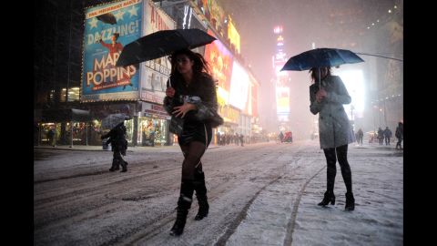 Two women look for a taxi in snow-covered Times Square on February 8.