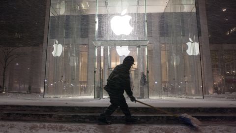 A man shovels snow in front of the Apple store in New York on February 8.