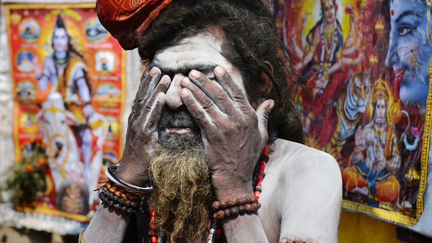 A Sadhu, or holy man, covers his face in ash at the grounds of the Kumbh Mela in Allahabad on February 9.