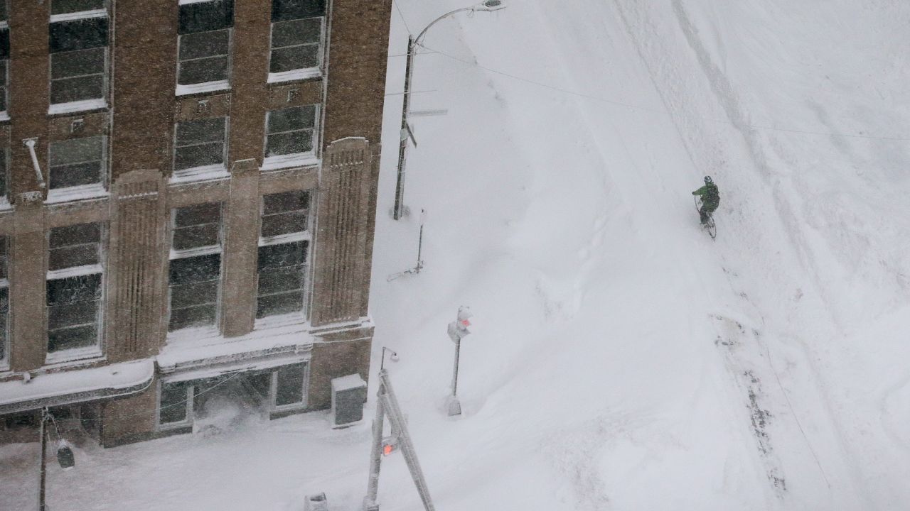 A cyclist rides through the snow in the Back Bay neighborhood of Boston.