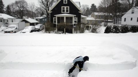 Mary Leahy shovels her sidewalk in Medford, Massachusetts.