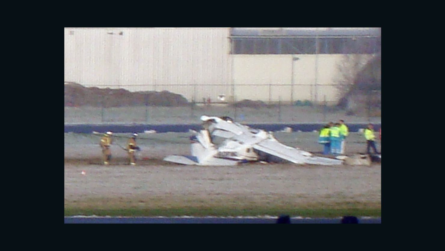 Rescuers gather around the crashed Cessna passenger plane at Brussels South airport in Charleroi, on February 9.