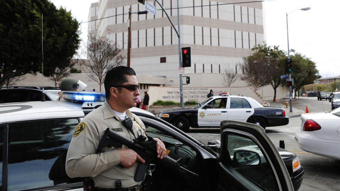 Officers keep watch outside of the Twin Towers Jail in response to an unconfirmed sighting of Dorner in Los Angeles.