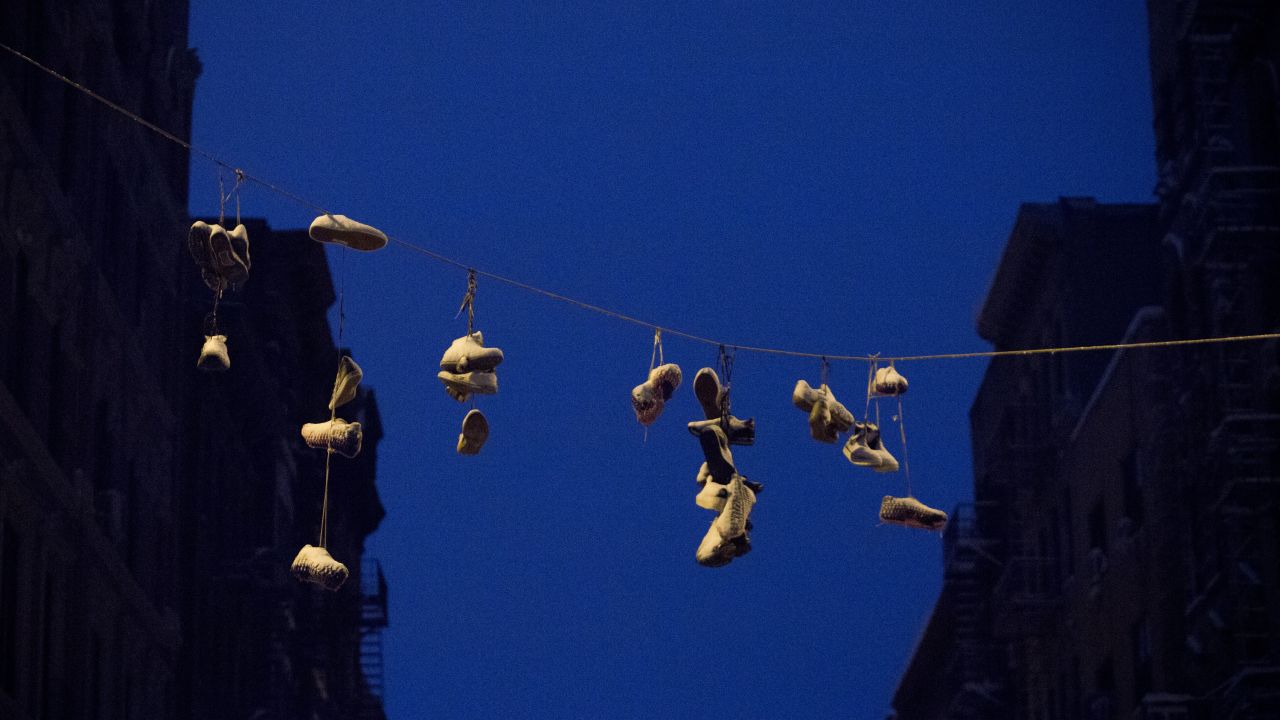 Snow gathers on shoes hung from power lines in the Lower East Side of New York City.