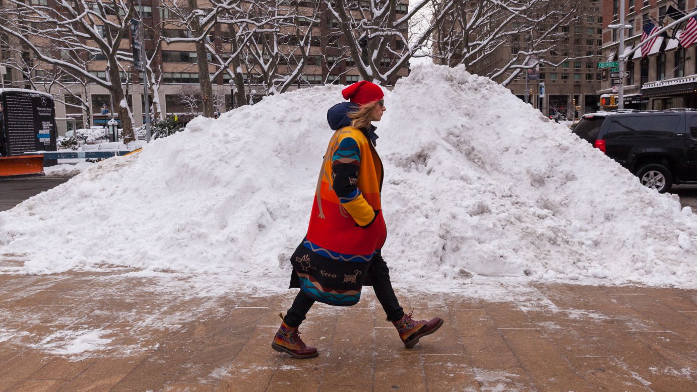 A model walks by a mound of snow on February 9.