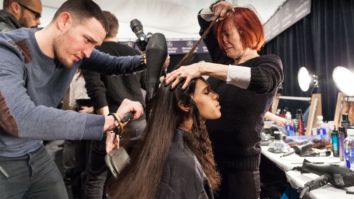 A model gets her hair straightened for the Mara Hoffman Show on February 9.