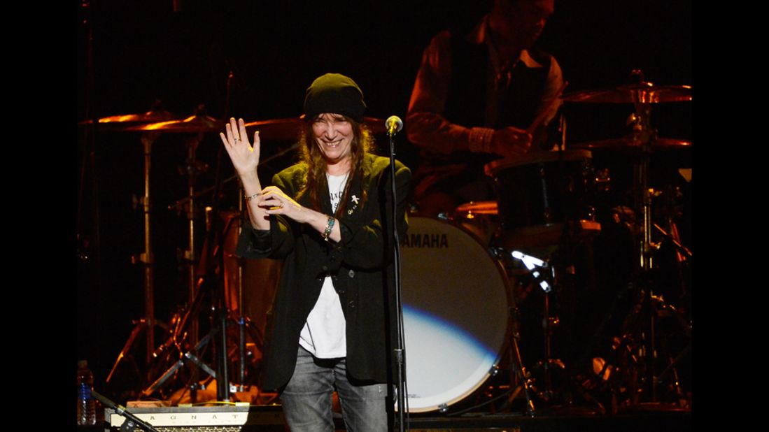 Singer Patti Smith waves to the audience during her performance of "Because the Night."