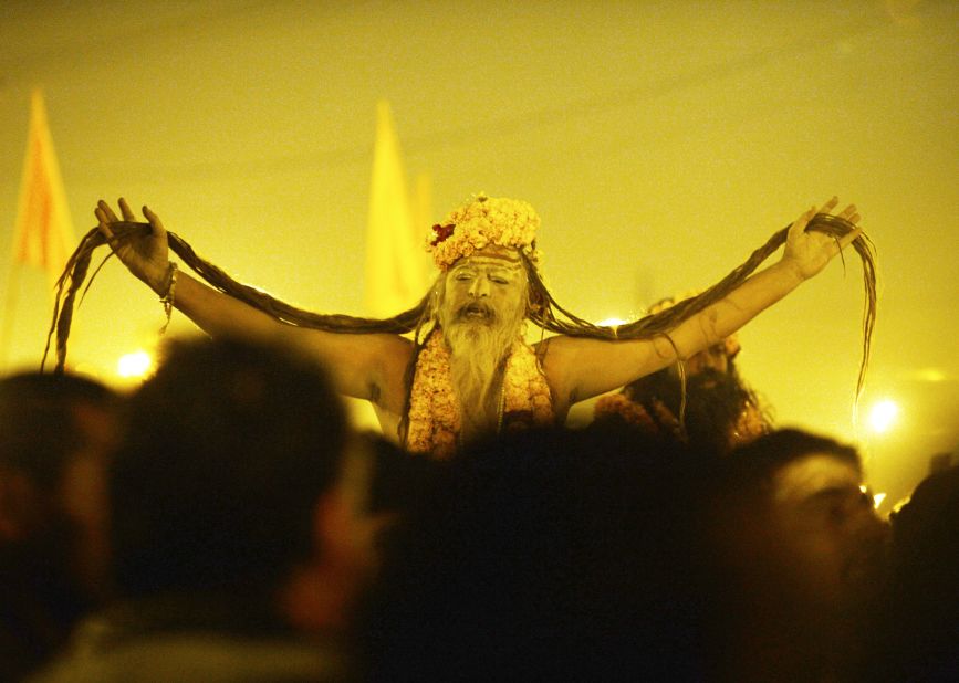 A naga sadhu, or holy man, shows off his 'jata' (long hair) as he marches to the Sangam on February 10. Naked saints covered with ash led the ritual bathing before dawn.   