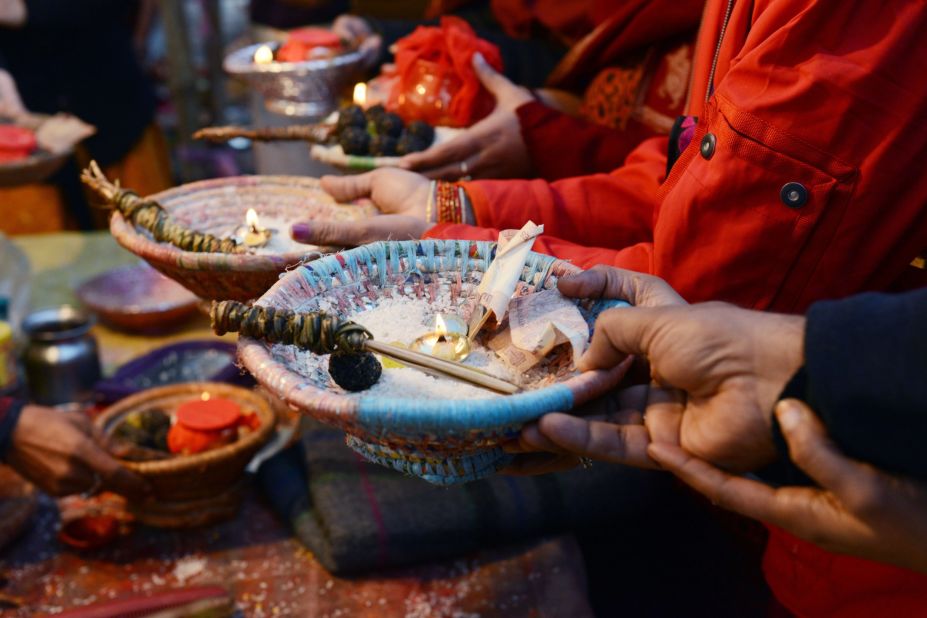 Hindu devotees hold offerings during a blessing ceremony on the banks of the Sangam on February 10.