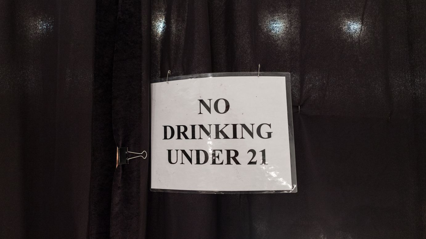 A laminated sign backstage on February 10 reminds models of the drinking age.