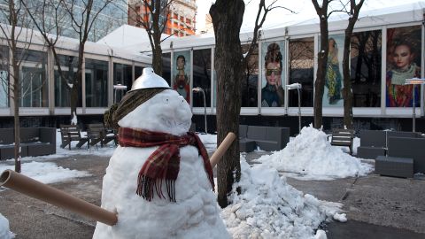 Snowmen made from backstage lamps, paper rolls and water bottle caps stand outside the rest area during Fashion Week in New York on February 10.