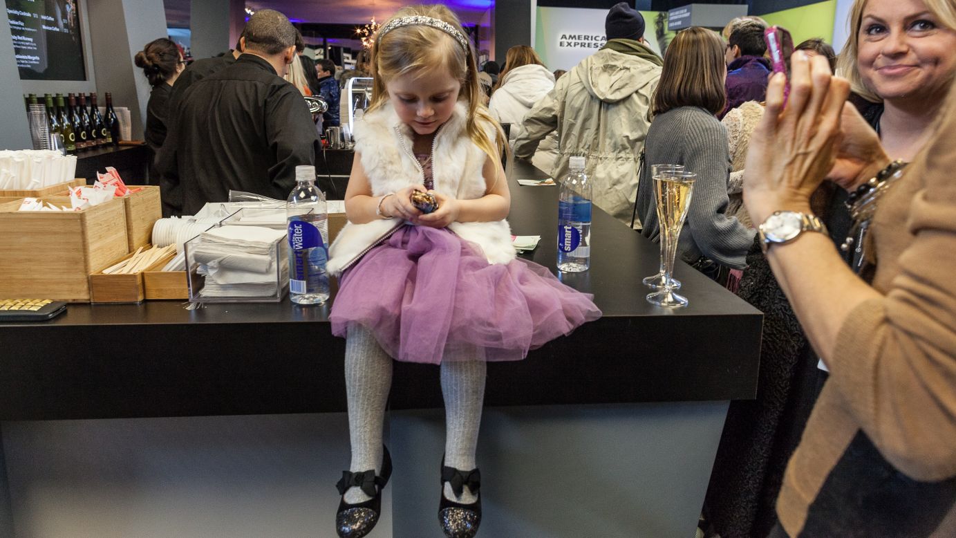 A young girl eats the free energy bar she got in the lobby during New York Fashion Week on Sunday, February 10. 