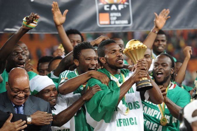 Nigeria's captain Joseph Yobo holds the Africa Cup of Nations trophy, which had been handed to him by South African President Jacob Zuma (L) at Soccer City stadium in Johannesburg.