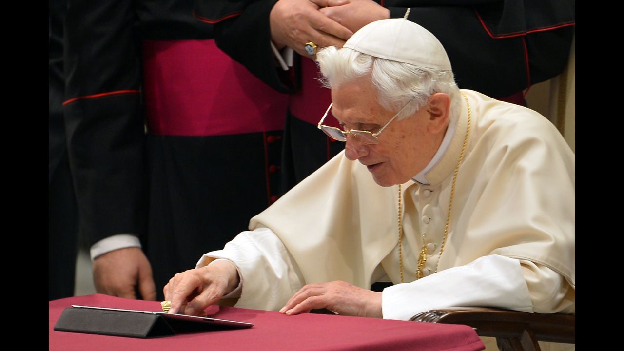 Benedict clicks on a tablet to send his first tweet from his account @pontifex at the Vatican in December 2012.